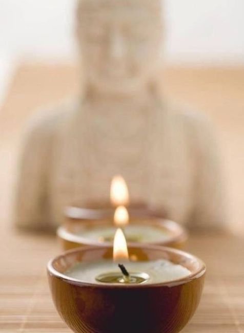 Buddha with lighted candle