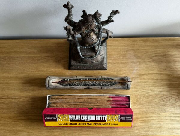 A pack of incense sticks and a holder