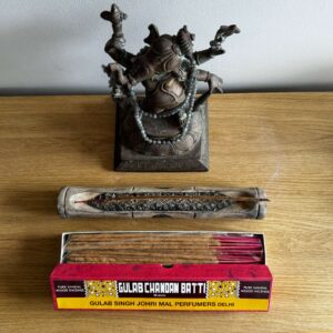 A pack of incense sticks and a holder